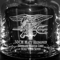 engraved taylor whiskey decanter with navy seal trident logo - closeup