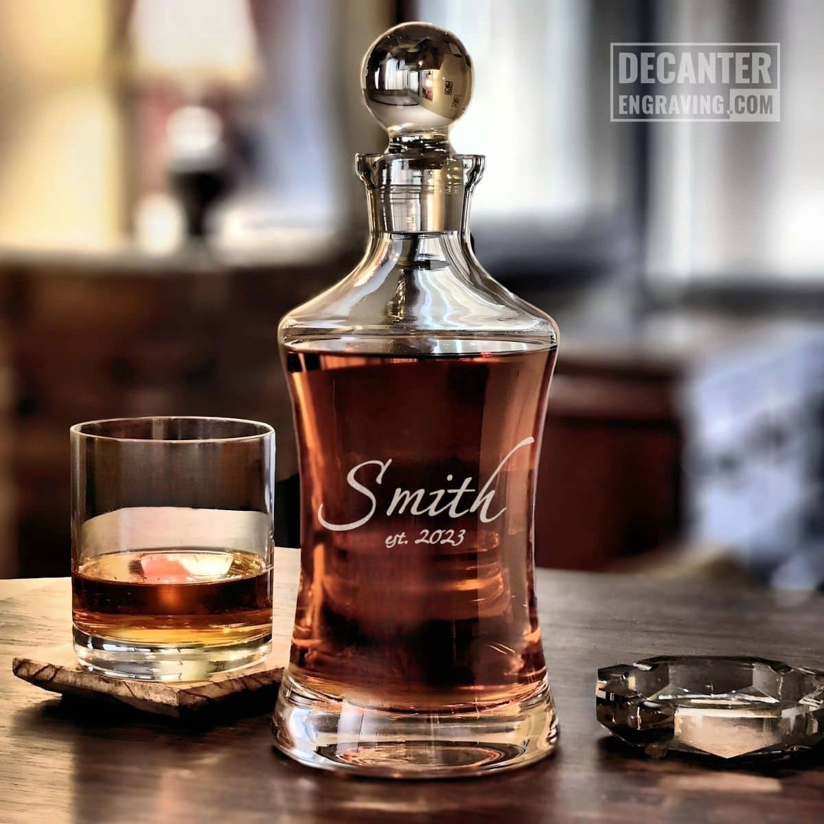Hourglass Whiskey Decanter | Arlo 17 Personalized Hourglass crystal whiskey decanter with custom engraved Arlo script signature design, shown with matching whiskey glass.