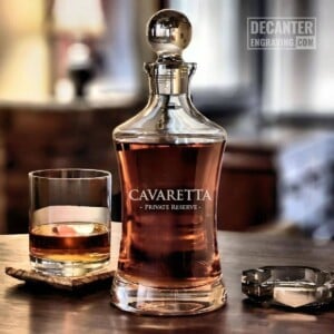 Hourglass Whiskey Decanter | Essence 8 Personalized Hourglass crystal whiskey decanter with custom engraved Essence reserve wordmark design, shown with matching whiskey glass.
