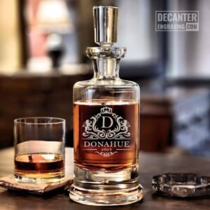 Personalized Kensington lead-free crystal whiskey decanter with custom engraved Park regal heraldic crest design, shown with matching whiskey glass.
