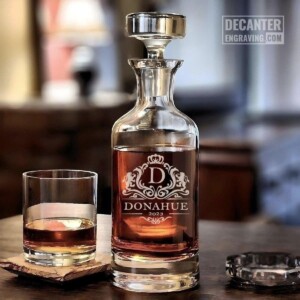 Personalized Wellington lead-free crystal whiskey decanter with custom engraved Park regal heraldic crest design, shown with matching whiskey glass.