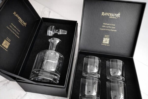 Two-piece luxury gift box set for custom engraved crystal whiskey decanters and four glasses, featuring premium gold-foil stamping and silk-lined custom foam inserts.